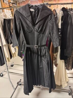 Teri Jon Rickie Freeman pleated V-neck dress with a buckle belt.
